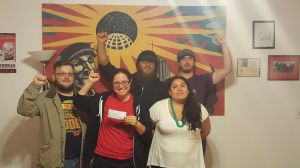 Fellow Worker Anja with her paycheck and Twin Cities IWW supporters. photo from TCOrganizer.com